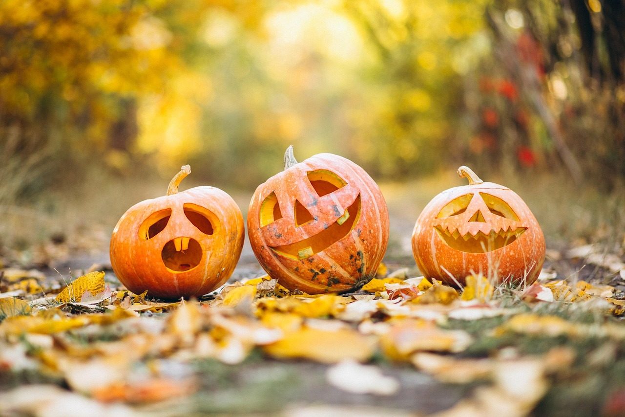 A whimsical Halloween scene with pumpkins, ghosts and spooky decor